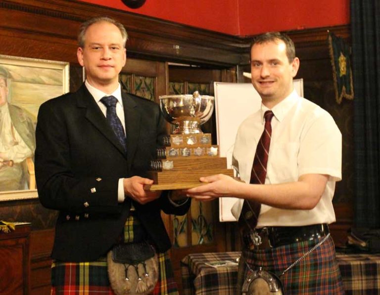 PPBSO President, Chris Buchanan hands the trophy to Andrew Carlisle.