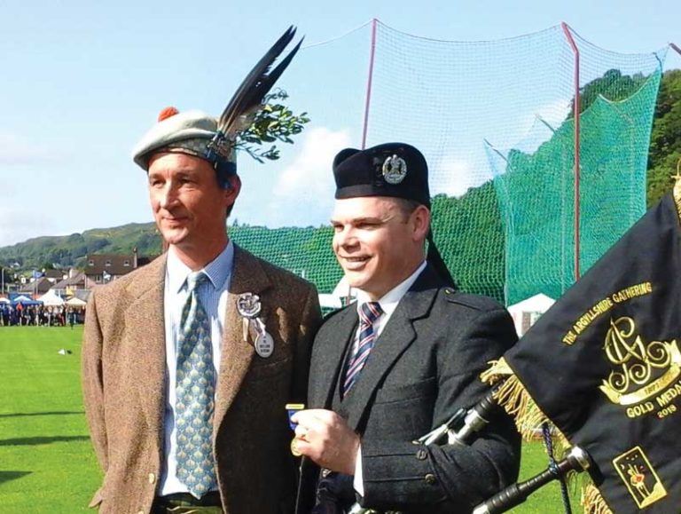 The Duke of Argyll presents Stuart Easton with the Gold Medal and pipe banner at Oban Games 2018.