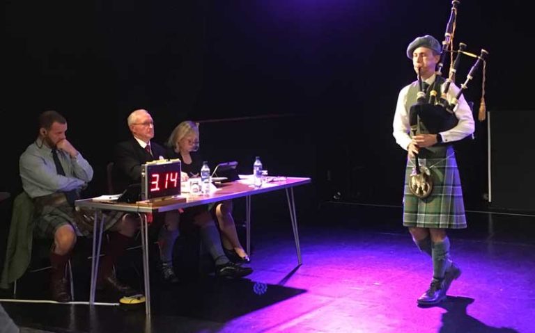 Connor Sinclair competing at last year's Argyllshire Gathering for judges Chris Armstrong, Ronnie McShannon and Patricia Henderson.