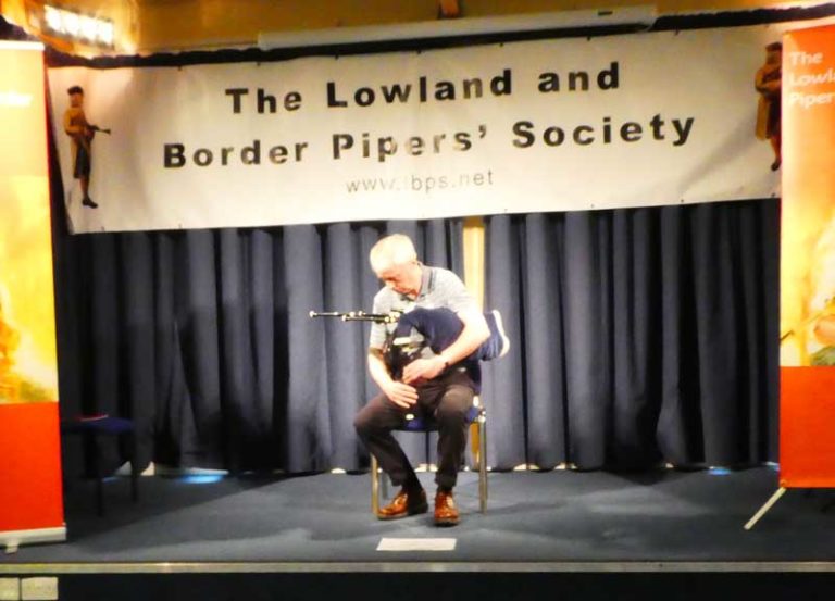 A competitor playing in a Smallpipe category at the 2019 competition held at The National Piping Centre Otago Street.